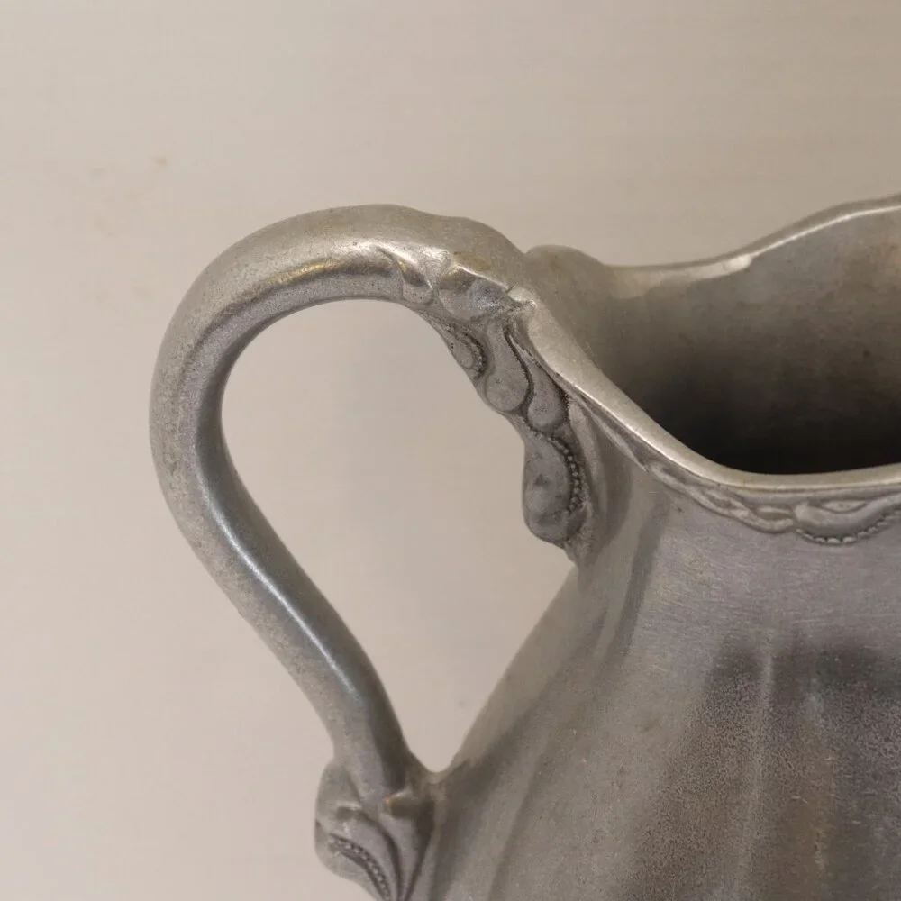 A Heavy Pewter Water Pitcher Pre Owner with some signs of wear